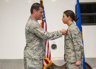 Lt. Col. Matthew Imperial (right), 96th Communication Squadron commander, presents Airman 1st Class Jaylyn Smith, 96th CS cable and antenna systems, with an Air Force Commendation Medal at an awards ceremony June 20 on Eglin Air Force Base, Fla. Smith was one of two Airmen recognized for life-saving care in response to a severe vehicle accident in February. (U.S. Air Force photo/Jasmine Porterfield)