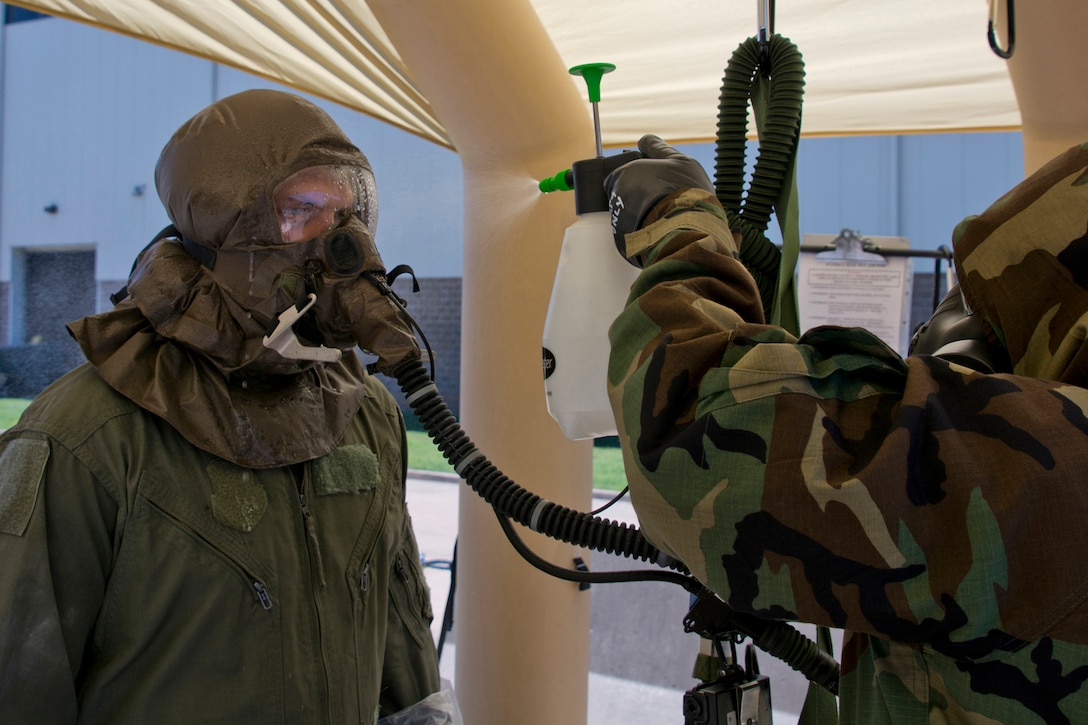 Air Force Reserve Staff Sgt. Michael Richardson, an aircrew flight equipment specialist assigned to the 913th Operations Support Squadron, sprays a simulated 5 percent chlorine solution on Staff Sgt. Michael Hopson, a loadmaster with the 327th Airlift Squadron, in a Lightweight Inflatable Decontamination Systems shelter during decontamination training for aircrew flight equipment specialists at Little Rock Air Force Base, Ark., June 19, 2017.  Initial testing for the decontamination system took place here in November 2005, when officials from Air Mobility Command and Air Force Special Operations Command moved the location from Keesler Air Force Base, Miss., in the wake of Hurricane Katrina. Air Force photo by Master Sgt. Jeff Walston