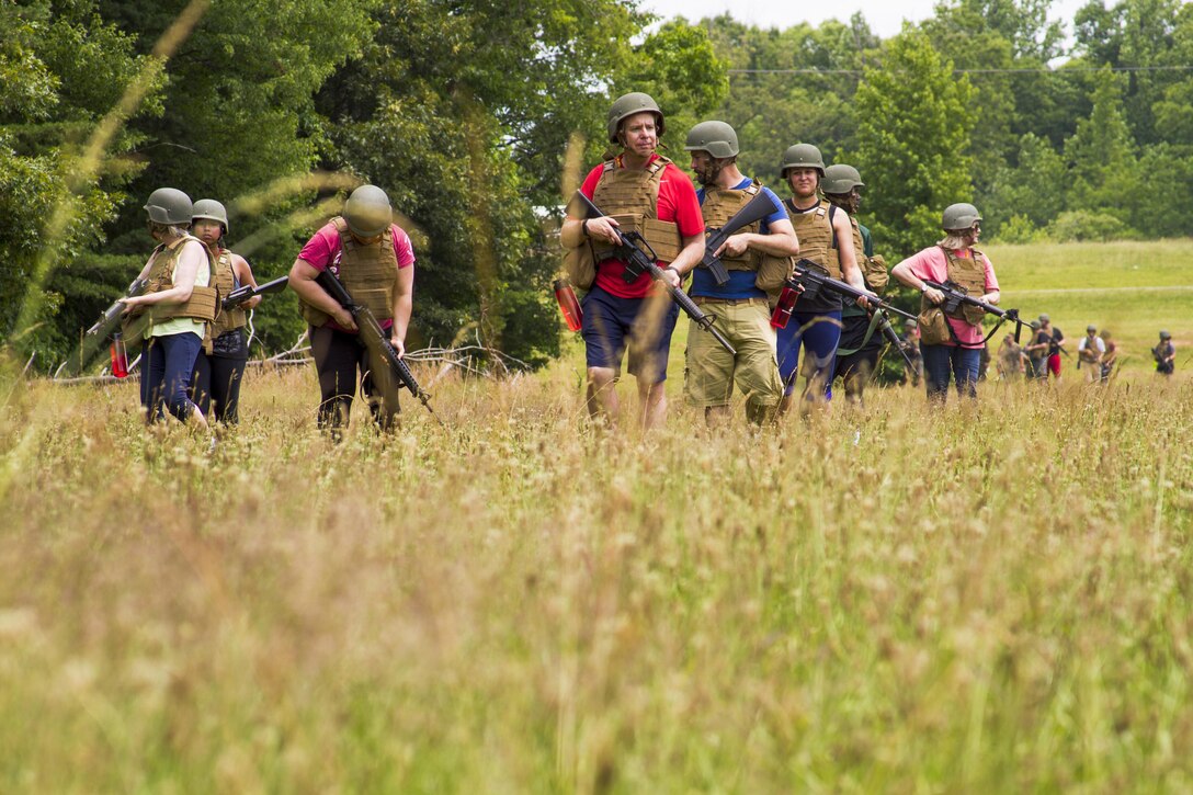 Approximately 50 Officer Selection Officers’ Educators’ and Key Leaders’ Workshop attendees practice patrolling at Marine Corps Base Quantico, Va., June 22, 2017. All visitors travelled from the Western Recruiting Region of the United States. The workshop began June 19 and ended June 23. During that time, guests received briefs about officer programs, conducted the Leadership Reaction Course, took flight aboard an MV22 Osprey and experienced many other events. The purpose of the engagement is to create a mutually beneficial relationship between educators and the Corps, where collegiate leaders share what they have learned about the Marines with their students, peers and bosses, based on first-hand experiences. (Photo by Lance Cpl. McHale)