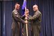 Col. Michael Drowley (left), U.S. Air Force Weapons School commandant, passes the 509th Weapons Squadron guidon to Lt. Col. Jeremy “Grimm” Gould (right), 509th WPS commander, during a change of command ceremony June 23, 2017, at Fairchild Air Force Base, Washington. Gould assumed command from Lt. Col. John “Yakko” Kelley. (U.S. Air Force photo/Senior Airman Nick J. Daniello)