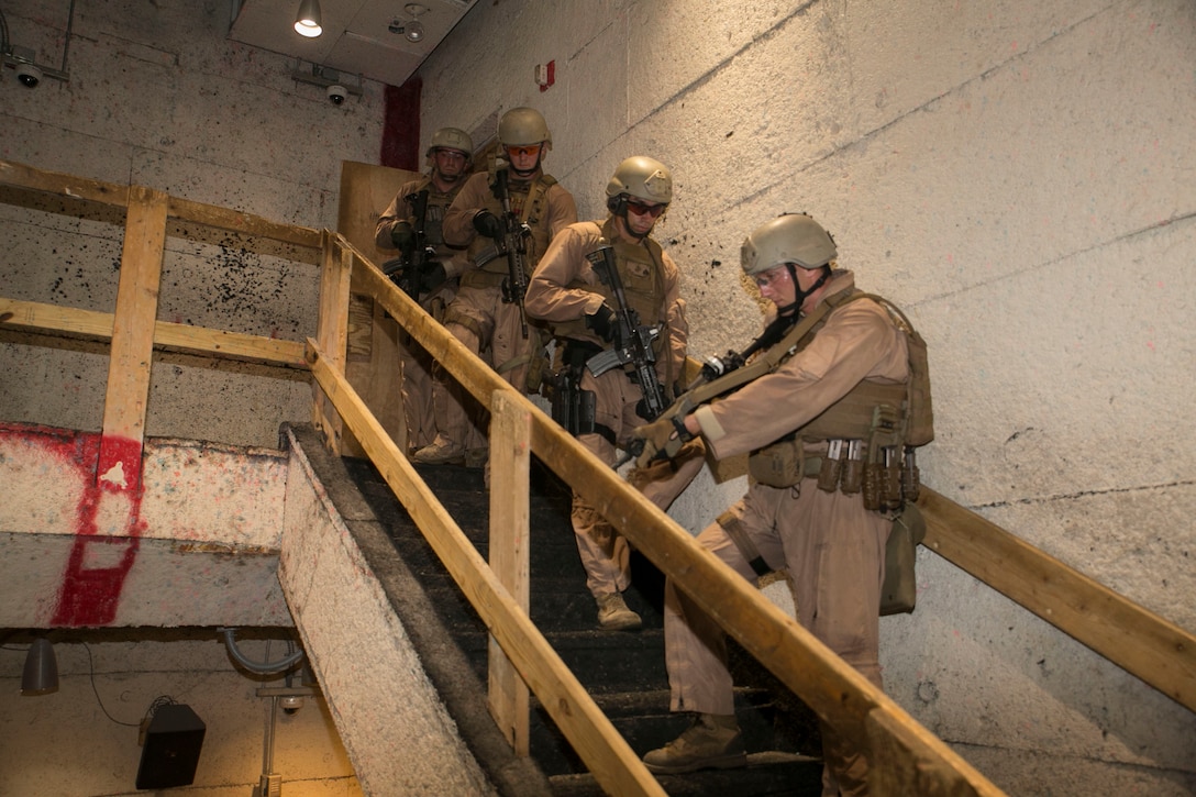 Staff Sgt. Joseph Pistone, chief instructor, Close Quarters Battle course, Training Co., Marine Corps Security Force Regiment, acts as point man as the Marines move from floor to floor clearing the building during instructor progression training at Naval Support Activity Northwest Annex, Chesapeake, Va., June 23. The instructors completed the tactical training as part of their quarterly requirements which also includes rifle and pistol range qualifications. (Official U.S. Marine Corps photo by Cpl. Logan Snyder/ Released)
