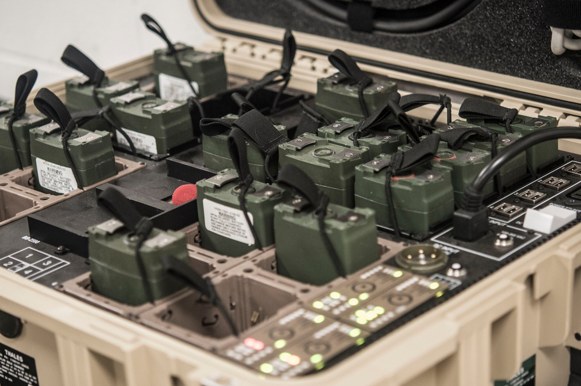 Senior Airman Christopher Shubin, mobile command and control communications technician with the 621st Contingency Response Support Squadron, Joint Base McGuire-Dix-Lakehurst, NJ, prepares Army Navy Portable Radio Communications (AN/PRC) 152a Multiband Radios for use during contingency response operations.  (U.S. Air Force photo by Staff Sgt. Robert Waggoner/RELEASED)