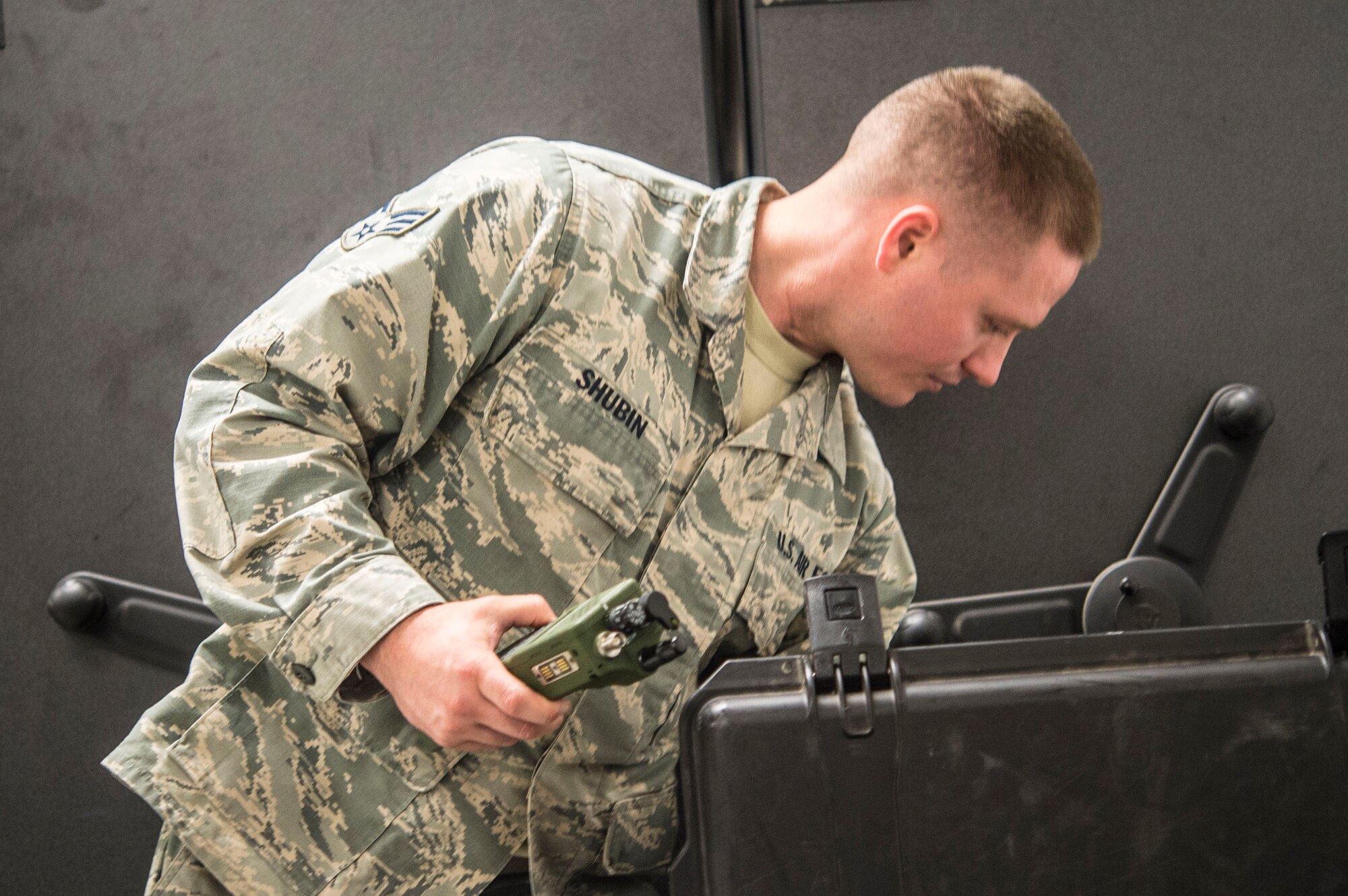 Senior Airman Christopher Shubin, Mobile C3 Technician with the 621st Contingency Response Support Squadron, Joint Base McGuire-Dix-Lakehurst, prepares Army Navy Portable Radio Communications (AN/PRC) 152a Multiband Radios for use during contingency response operations.  (U.S. Air Force photo by Staff Sgt. Robert Waggoner/RELEASED)