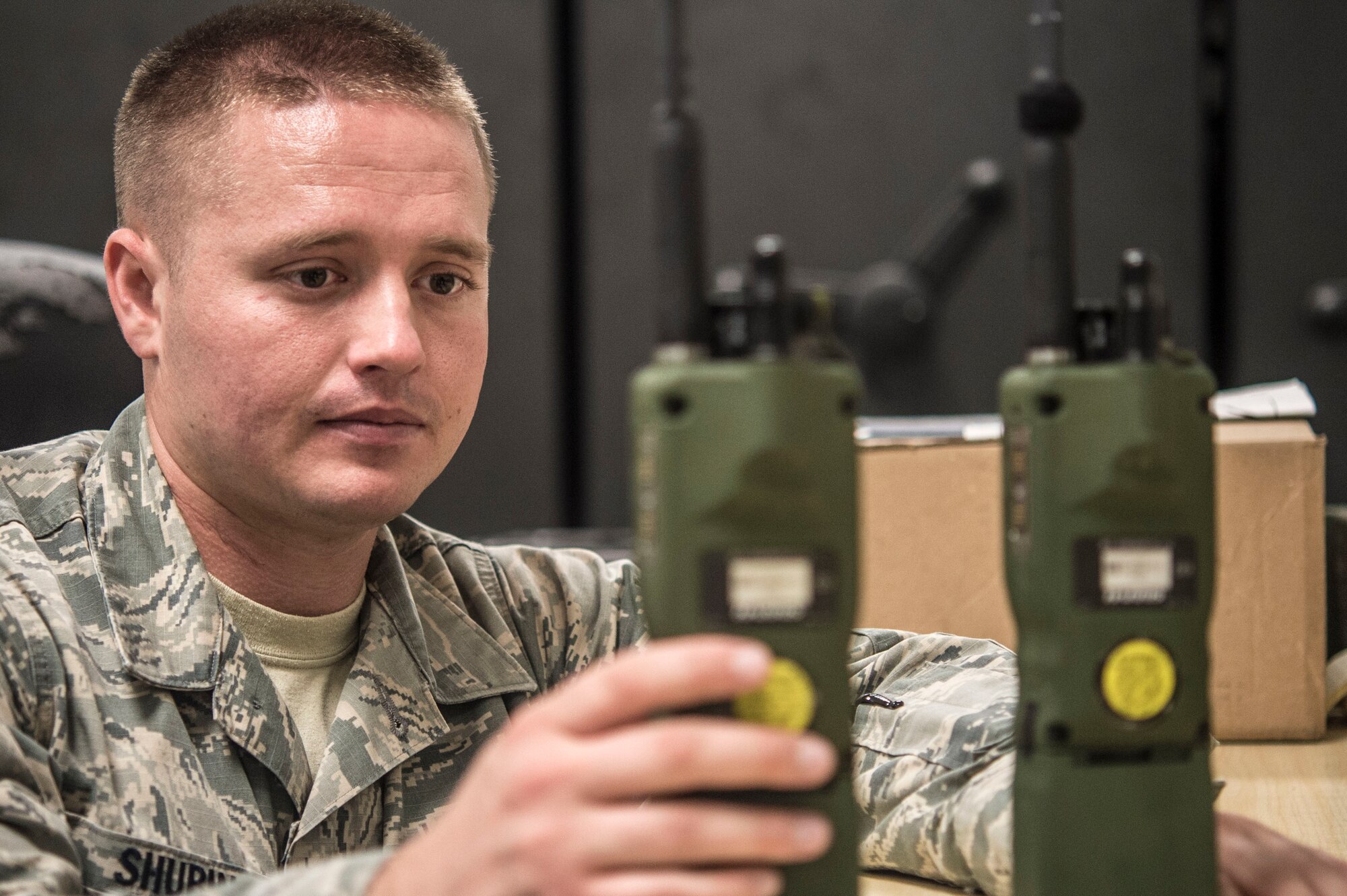 Senior Airman Christopher Shubin, mobile command and control communications technician with the 621st Contingency Response Support Squadron, Joint Base McGuire-Dix-Lakehurst, NJ, prepares Army Navy Portable Radio Communications (AN/PRC) 152a Multiband Radios for use during contingency response operations.  (U.S. Air Force photo by Staff Sgt. Robert Waggoner/RELEASED)