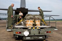 Loadmasters from the 327th Airlift Squadron check a heavy equipment training load before it is slid into the bay of a C-130J Super Hercules June 15, 2017, at Little Rock Air Force Base, Ark. Flying training missions enhances skills that are used during humanitarian and combat missions. (U.S. Air Force photo by Master Sgt. Jeff Walston/Released)