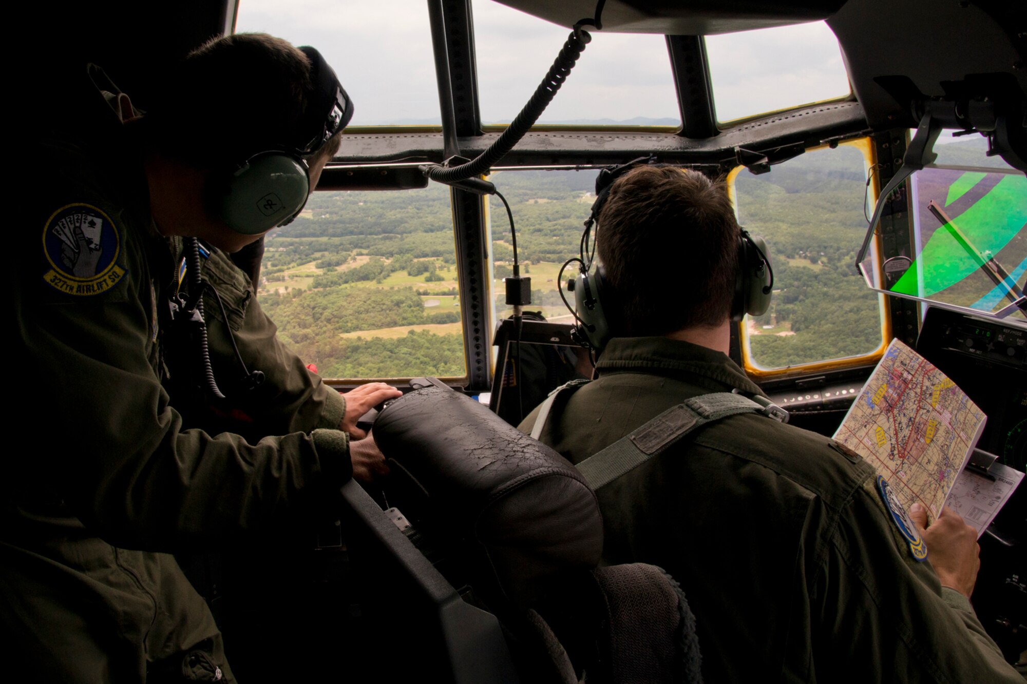 U.S. Air Force Reserve Staff Sgt. Michael Hopson, flight engineer, 327th Airlift Squadron, and Maj. Peter Hughes, pilot, 327 AS, check the landscape during a training flight in a C-130J Super Hercules June 15, 2017, near Little Rock Air Force Base, Ark. The sortie, manned entirely by Reserve Airmen, was a first for the 913th Airlift Group. (U.S. Air Force photo by Master Sgt. Jeff Walston/Released)