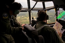 U.S. Air Force Reserve Staff Sgt. Michael Hopson, flight engineer, 327th Airlift Squadron, and Maj. Peter Hughes, pilot, 327 AS, check the landscape during a training flight in a C-130J Super Hercules June 15, 2017, near Little Rock Air Force Base, Ark. The sortie, manned entirely by Reserve Airmen, was a first for the 913th Airlift Group. (U.S. Air Force photo by Master Sgt. Jeff Walston/Released)
