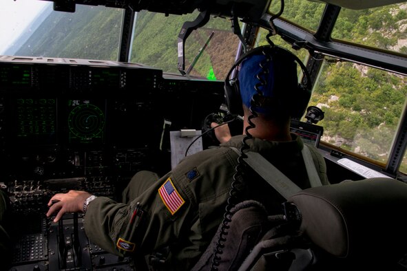 U.S. Air Force Reserve Lt. Col. Chris Dickens, assistant operations officer, 327th Airlift Squadron, looks at the Arkansas countryside during a training flight in a C-130J Super Hercules June 15, 2017, near Little Rock Air Force Base, Ark. Dickens was part of the 913th Airlift Group’s first 3-ship mission manned entirely by Reserve Airmen. (U.S. Air Force photo by Master Sgt. Jeff Walston/Released)