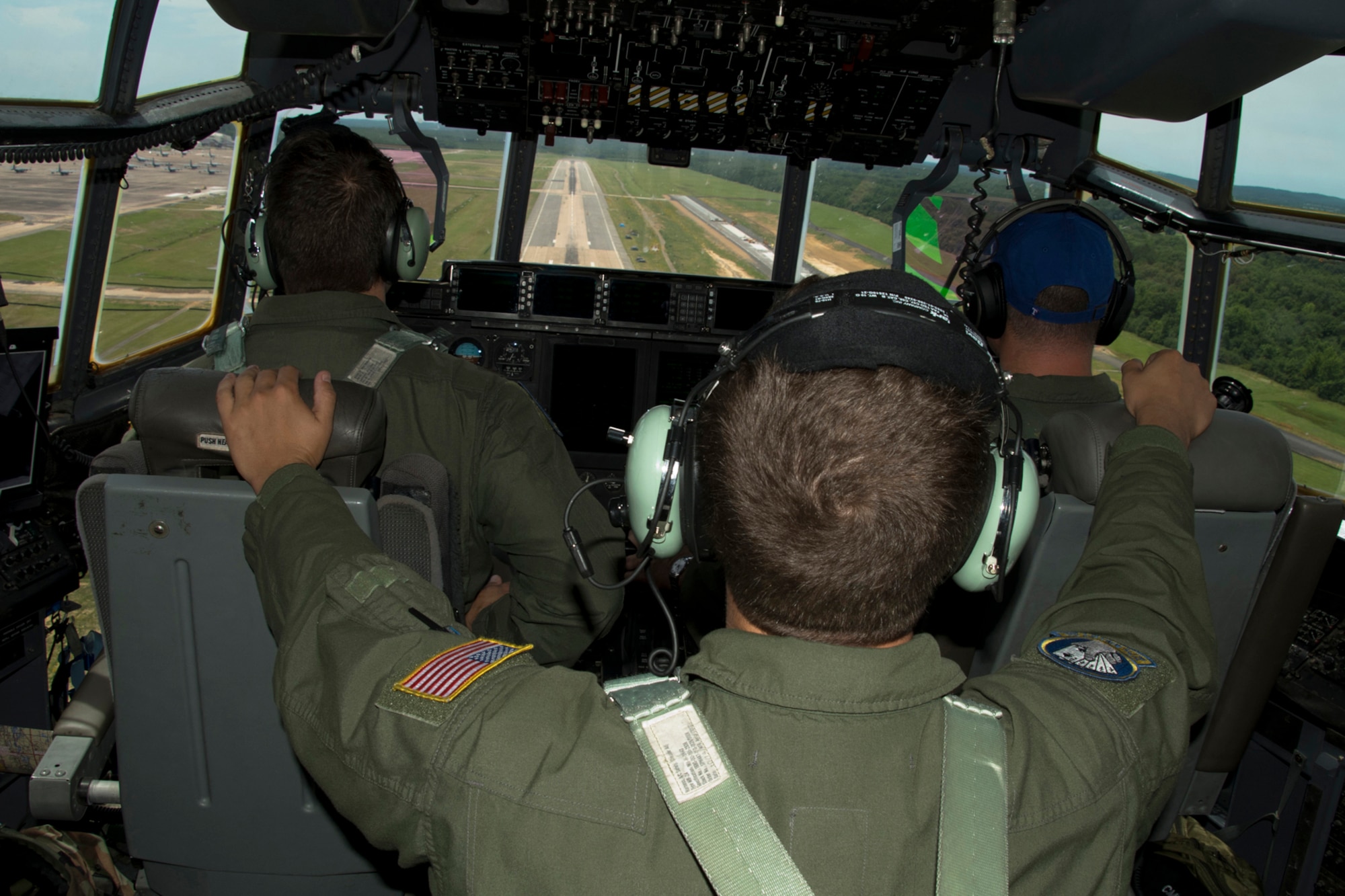 (From Left) U.S. Air Force Reserve Maj. Peter Hughes, pilot, Staff Sgt. Michael Hopson, flight engineer, and Lt. Col. Chris Dickens, assistant operations officer, prepare to land a C-130J Super Hercules at Little Rock Air Force Base, Ark., June 15, 2017. All three Airmen are assigned to the 327th Airlift Squadron, 913th Airlift Group, and were part of the Group’s first 3-ship mission manned entirely by Reserve Airmen. (U.S. Air Force photo by Master Sgt. Jeff Walston/Released)