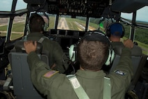 (From Left) U.S. Air Force Reserve Maj. Peter Hughes, pilot, Staff Sgt. Michael Hopson, flight engineer, and Lt. Col. Chris Dickens, assistant operations officer, prepare to land a C-130J Super Hercules at Little Rock Air Force Base, Ark., June 15, 2017. All three Airmen are assigned to the 327th Airlift Squadron, 913th Airlift Group, and were part of the Group’s first 3-ship mission manned entirely by Reserve Airmen. (U.S. Air Force photo by Master Sgt. Jeff Walston/Released)