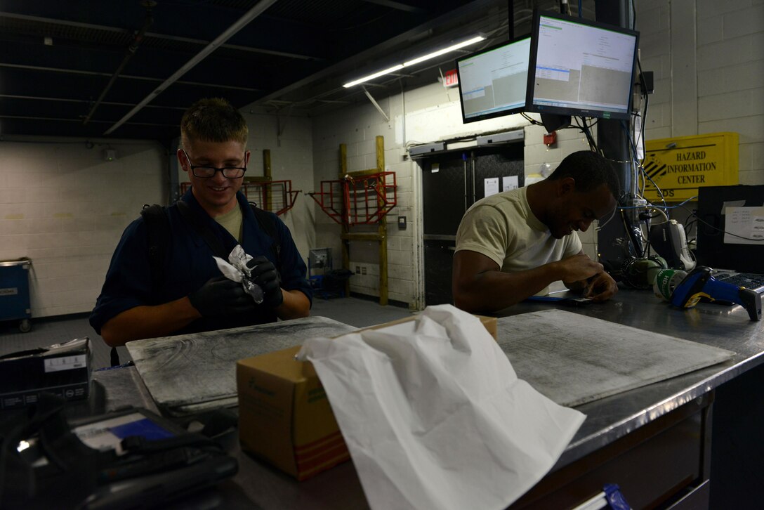 U.S. Air Force Airman 1st Class Alex Hoopingarner, left, and Staff Sgt. Andre Coke, 20th Aircraft Maintenance Squadron, Shooters Aircraft Maintenance Unit (AMU) tactical aircraft maintainers, clean and inspect equipment prior to returning it to the Shooters AMU support section at Shaw Air Force Base, S.C., June 26, 2017. By cleaning and inspecting the equipment’s serviceability, maintainers help to preserve the longevity of the tools in the support section, which acts as an equipment library. (U.S. Air Force photo by Airman 1st Class Destinee Sweeney)