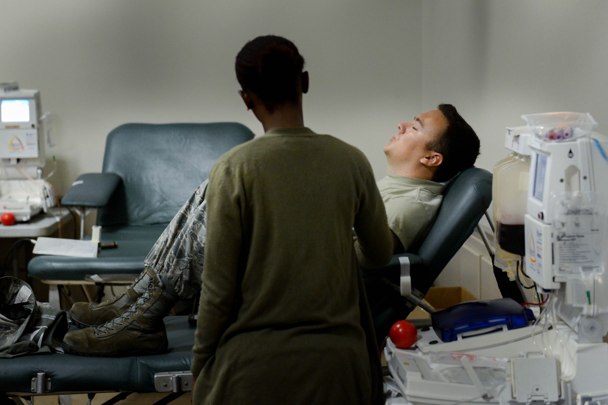 A LifeShare technician assists a donor as he gives blood during the 2017 LifeShare Blood Drive at Barksdale Air Force Base, La., June 16, 2017. Approximately 32,000 pints of blood are used each day in the United States. (U.S. Air Force Photo/Airman 1st Class Sydney Bennett)