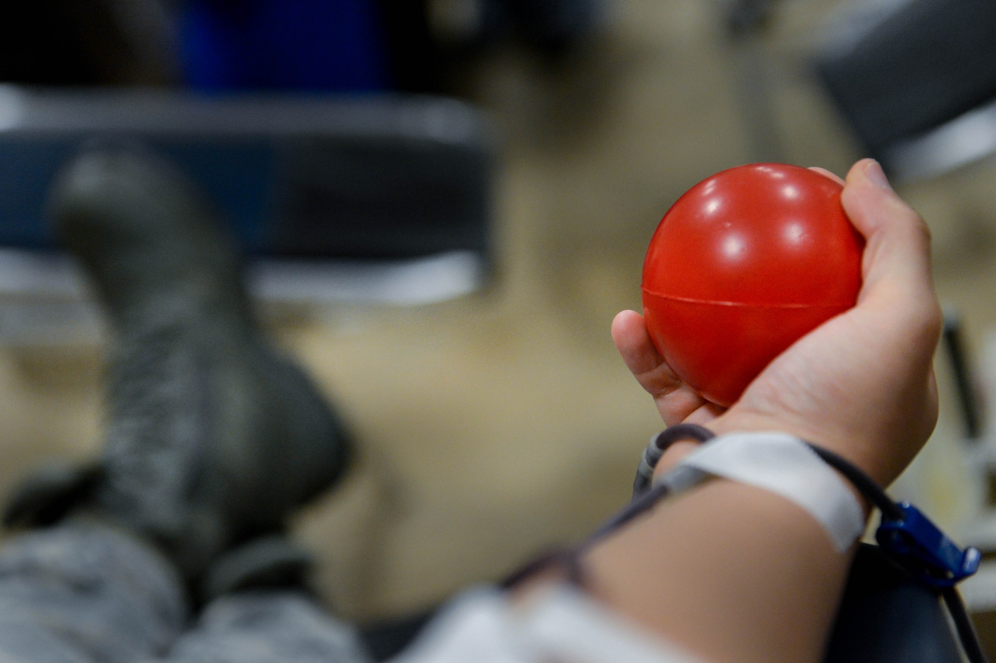 An Airman squeezes a stress ball as he donates blood at the 2017 LifeShare Blood Drive at Barksdale Air Force Base, La., June 16, 2017. Approximately every two seconds someone in the U.S. needs blood.(U.S. Air Force Photo/Airman 1st Class Sydney Bennett)