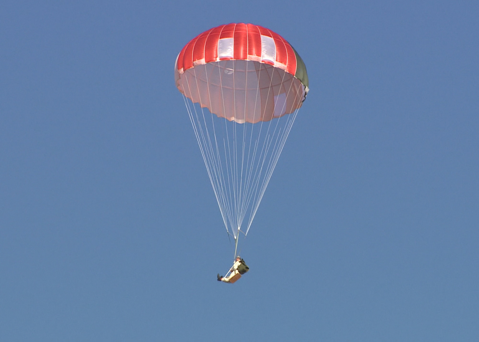 A GR7000 parachute along with dummy descends over a drop zone near Edwards Air Force Base. A team from the 418th Flight Test Squadron conducted several drops using the parachute, which has been proposed as a replacement for the current C-9 canopy used in the ACES II ejection seat. (U.S. Air Force image provided by Brad White)