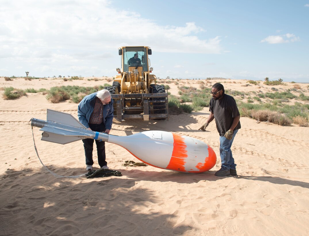 Members of the 418th Flight Test Squadron recover a crosswind deployment cylindrical test vehicle, which was used to test a GR7000 parachute last month. Dummies and live personnel were also used to test the parachute, which is proposed as a replacement for the current C-9 canopy currently used on ACES II ejection seats. (U.S. Air Force photo by Ethan Wagner)