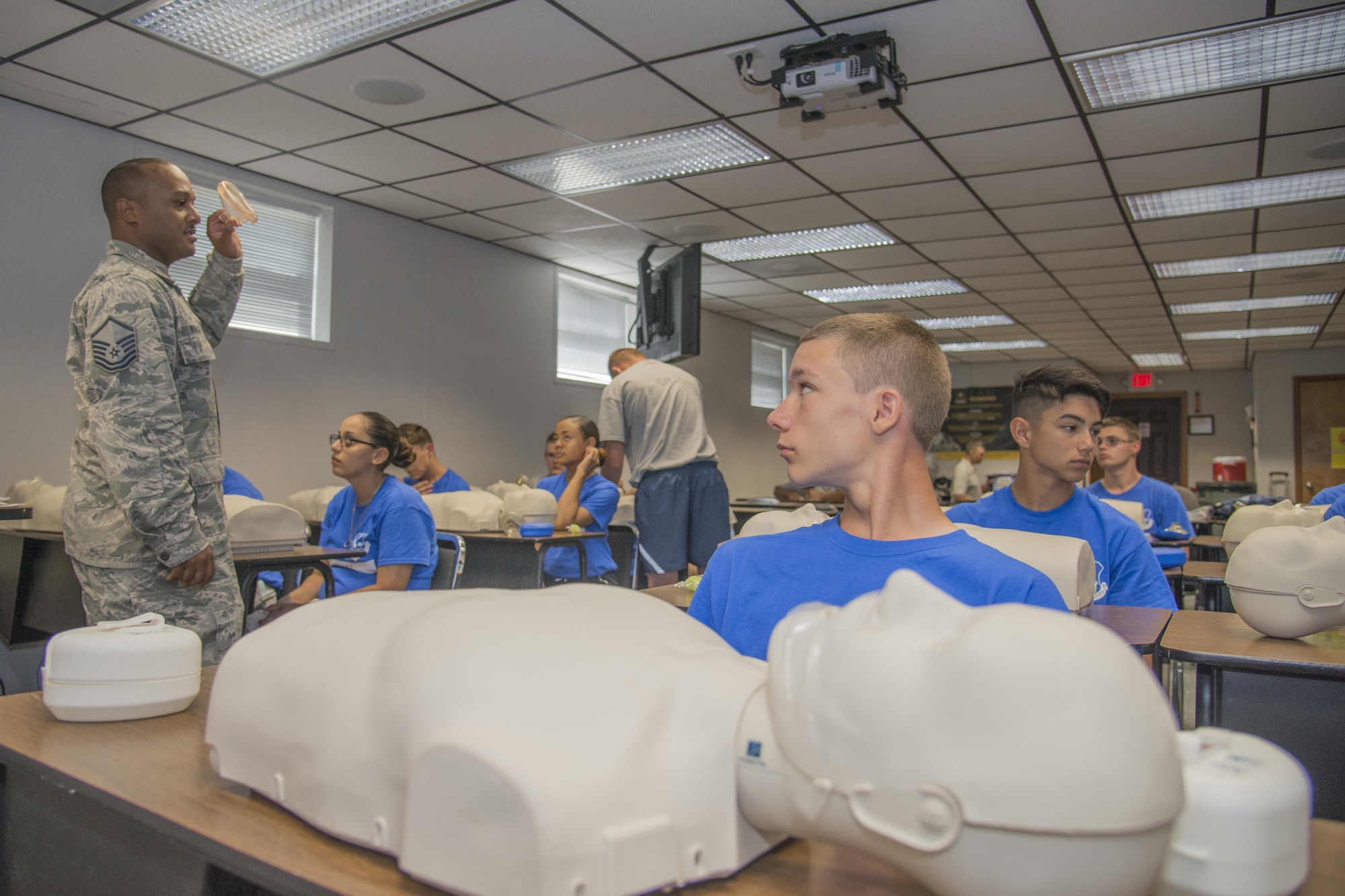 Master Sgt. Jason Walls, 436th Medical Operations Squadron family health flight chief, teaches CPR to a class of Junior ROTC cadets during the Delaware Cadet Leadership Course June 21, 2017, at the Delaware National Guard training site at Bethany Beach, Del. Several Airmen from Dover Air Force Base attended the event to assist with the cadets’ training. (U.S. Air Force photo by Staff Sgt. Jared Duhon)