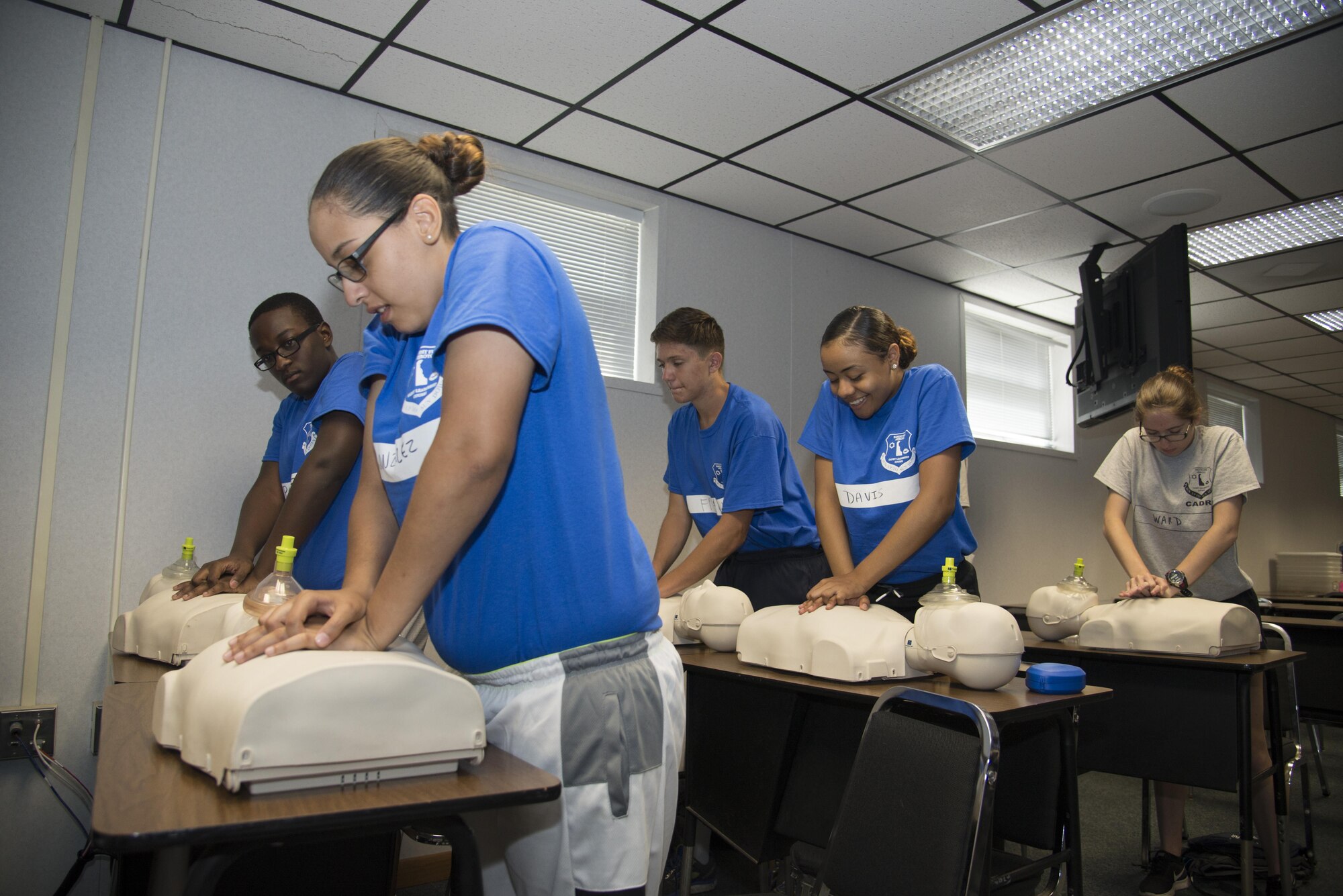 Junior ROTC cadets practice chest compressions during the Delaware Cadet Leadership Course June 21, 2017, at the Delaware National Guard training site at Bethany Beach, Del. Each year, cadets from six schools around the state attend the week-long summer camp where they learn practical hands-on lessons and skills. (U.S. Air Force photo by Staff Sgt. Jared Duhon)