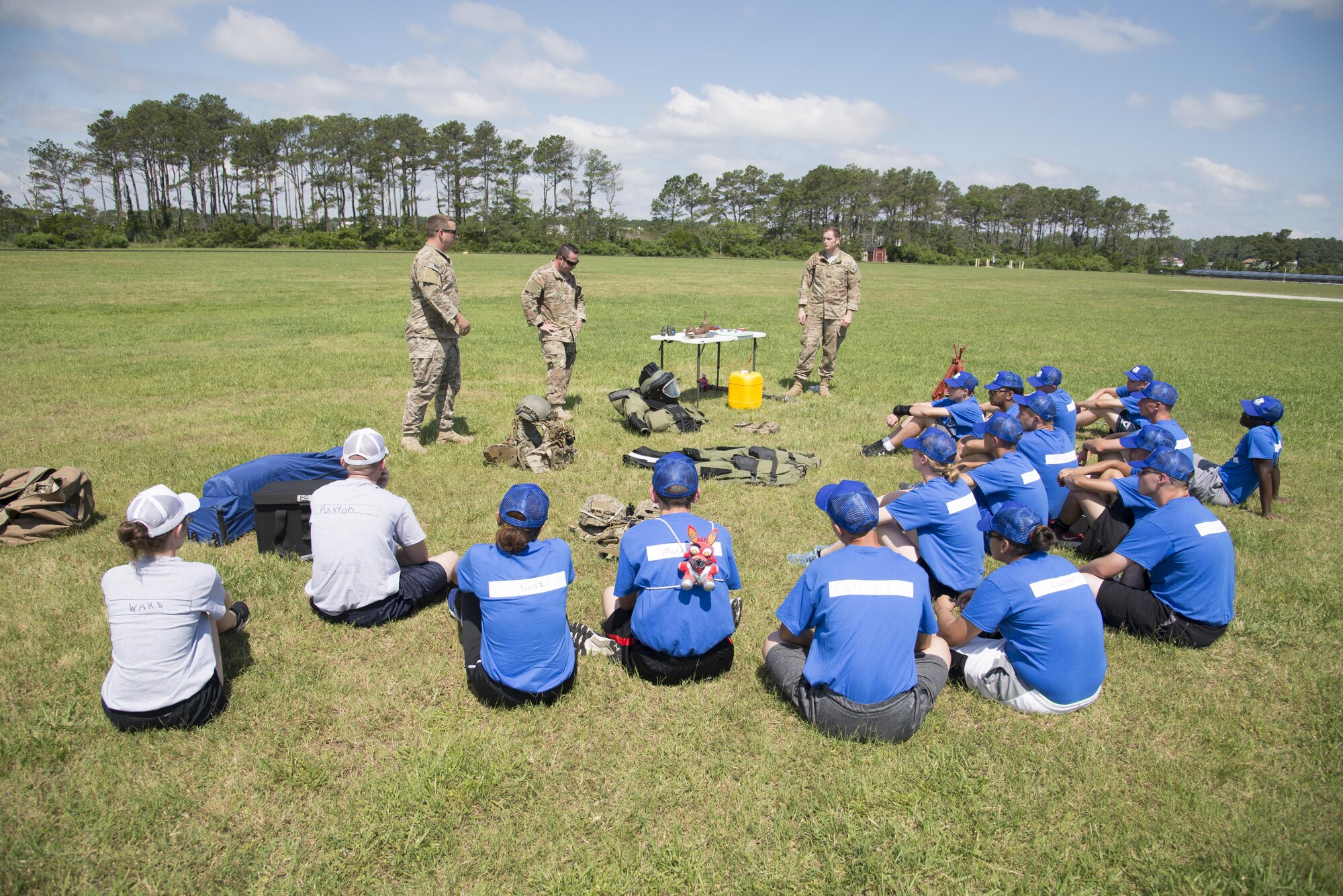 Explosive ordnance disposal technicians assigned to the 436th Civil Engineer Squadron answer questions during the Delaware Cadet Leadership Course June 21, 2017, at the Delaware National Guard training site at Bethany Beach, Del. One hundred cadets from around the state attended the week-long summer camp. (U.S. Air Force photo by Staff Sgt. Jared Duhon)