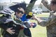 Senior Airman Joel Miller, 436th Civil Engineer Squadron explosive ordnance disposal technician, helps a Junior ROTC cadet try on a bomb suit during the Delaware Cadet Leadership Course June 21, 2017, at the Delaware National Guard training site at Bethany Beach, Del. A full bomb suit weighs more than 70 pounds and can withstand an explosion of five pounds of bare explosives at a distance of five feet. (U.S. Air Force photo by Staff Sgt. Jared Duhon)