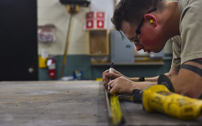 Airman 1st Class Wayne Lee, 628th Civil Engineer Squadron structural apprentice, measures an angle iron for a table leg at Joint Base Charleston, S.C., June 23, 2017. The 628th CES structures shop helps maintain structures, such as buildings and other government property, across the Air Base and Weapons Station.