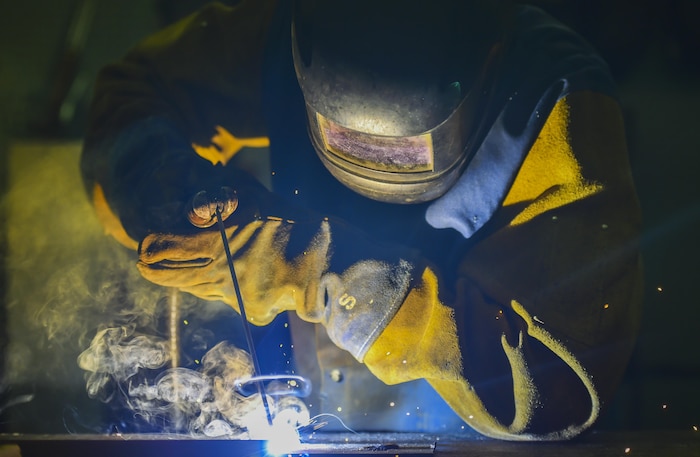 Airman 1st Class Wayne Lee, 628th Civil Engineer Squadron structural apprentice, welds an angle iron for a table leg at Joint Base Charleston, S.C., June 23, 2017. The 628th CES is also responsible for fabricating and repairing components of buildings, utility systems and property equipment.