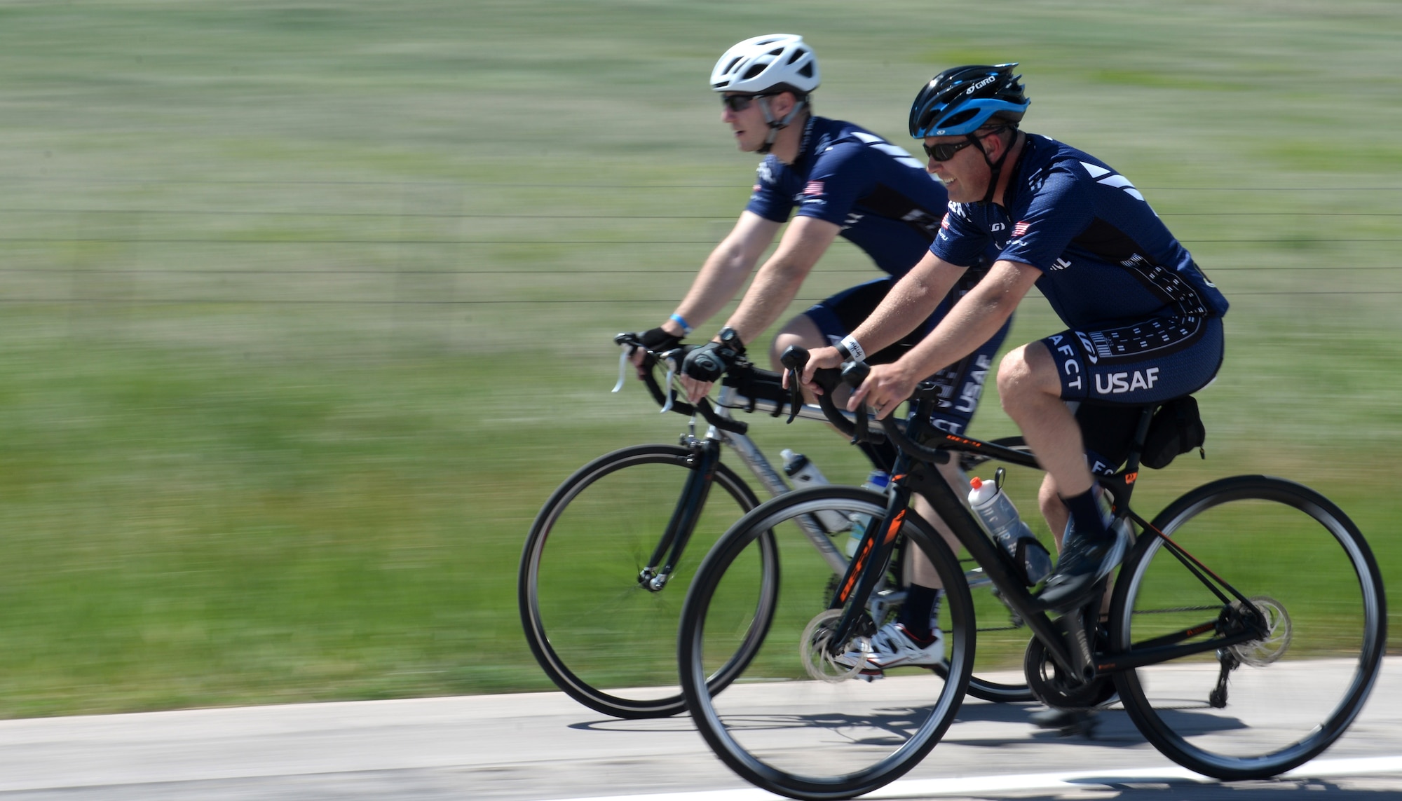 Maj. Anthony Bares, the director of wing inspections assigned to the 28th Bomb Wing Inspector General office, front, and Capt. Eben Engler, a B-1 bomber weapon systems officer assigned to the 34th Bomb Squadron, back, cycle toward Caputa, S.D., during the Ride Across South Dakota, June 4, 2017. The ride was one of two local events members of the Dakota Regional Air Force Cycling Team participated in as preparation for the Register’s Annual Great Bicycle Ride Across Iowa July 23-29. (U.S. Air Force photo by Airman 1st Class Thomas Karol)