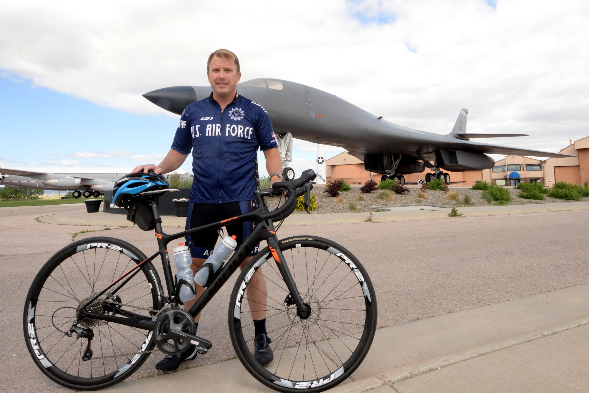 Maj. Anthony Bares, the director of wing inspections assigned to the 28th Bomb Wing Inspector General office, poses with his bike at the South Dakota Air and Space Museum, Box Elder, S.D., June 23, 2017. Bares currently leads the Dakota Regional Air Force Cycling Team, which includes six Airmen assigned to Ellsworth, five Airmen from Minot AFB, N.D., two Air Force reservists and two civilians. (U.S. Air Force photo by Staff Sgt. Hailey Staker)
