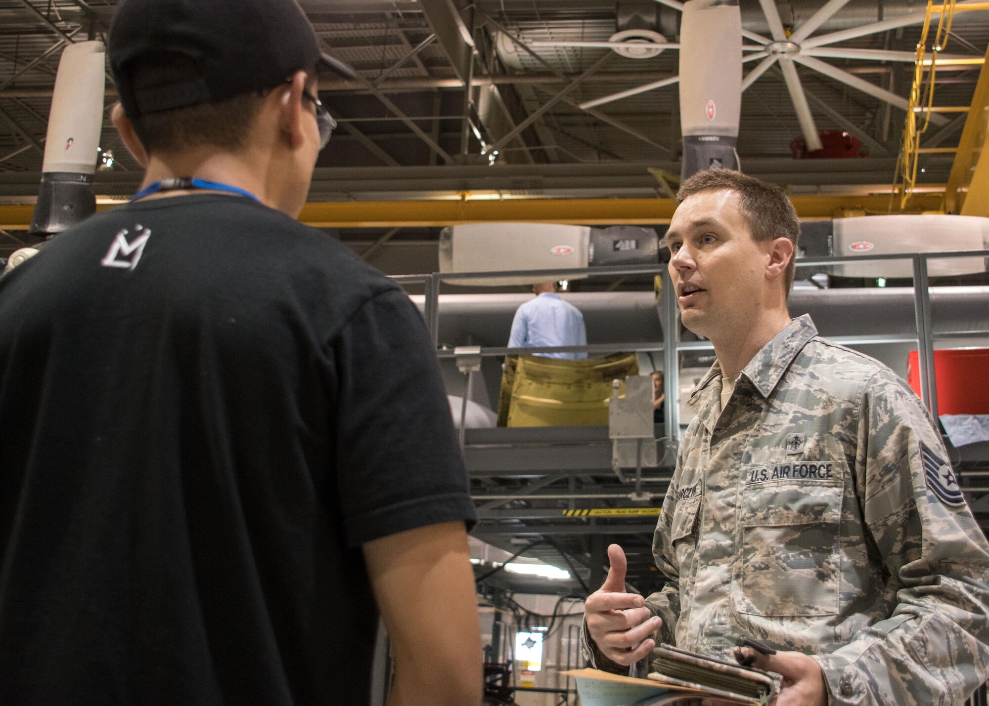 Tech. Sgt. Sean Slusarczyk, an Air Force Reserve recruiter based in Duluth, Ga., right, talks with a student from the Aviation Institute of Maintenance school in a hangar at Dobbins Air Reserve Base, Ga. June 23, 2017. Recruiters and faculty members partnered to create an opportunity for students to explore the Air Force Reserve as a possible career path upon graduation. (U.S. Air Force photo/Staff Sgt. Andrew Park)