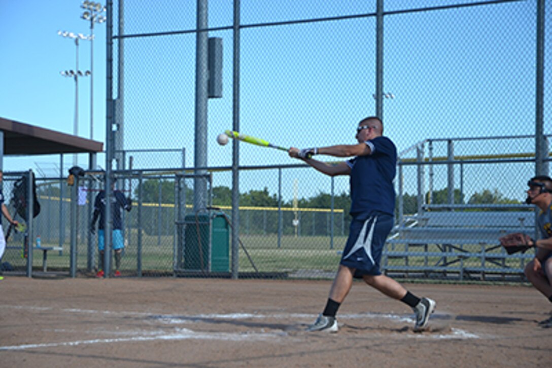 Matthew Michael, 552nd MXS/AGE right fielder, connects for a base hit in the top of the third June 19 at Championship Field. (Air Force photo by Airman 1st Class Elliot Scott)