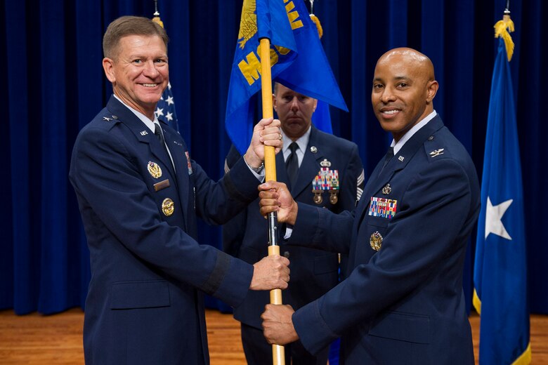Brig. Gen. Wayne Monteith, 45th Space Wing commander, presents Col. Kevin L. Williams, 45th Mission Support Group commander, with a guidon during a change of command ceremony June 16, 2017, at Patrick Air Force Base, Fla. Changes of command are a military tradition representing the transfer of responsibilities from the presiding official to the upcoming official. (U.S. Air Force photo by Phil Sunkel) 