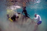 Explosive Ordnance Disposal Technician 2nd Class Mike Jones, assigned to Explosive Ordnance Disposal Mobile Unit (EODMU) 5, dives off the coast of Guam June 12, 2017, as part of the Western Pacific Naval Symposium Diving Exercise (WPNS-DIVEX) 2017. WPNS-DIVEX 2017 is a biennial diving exercise conducted by WPNS nations to enhance cooperation, interoperability, and tactical proficiency in diving operations in support of disaster response.