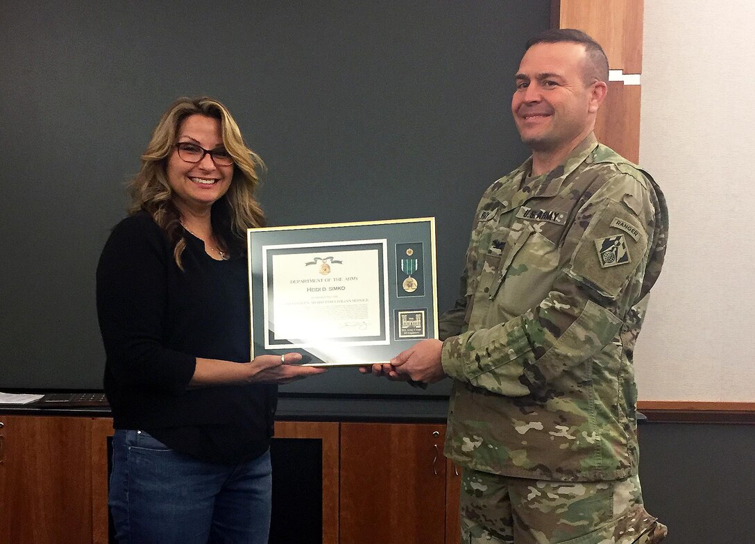Heidi Simko, a regulatory assistant for the U.S. Army Corps of Engineers Sacramento District, is presented the Commander's Award from Col. David Ray, Sacramento District commander on May 24, 2017. Simko was named District Regulator of the Year for 2016, earning the Randy Snyder Regulatory Excellence Award. 
