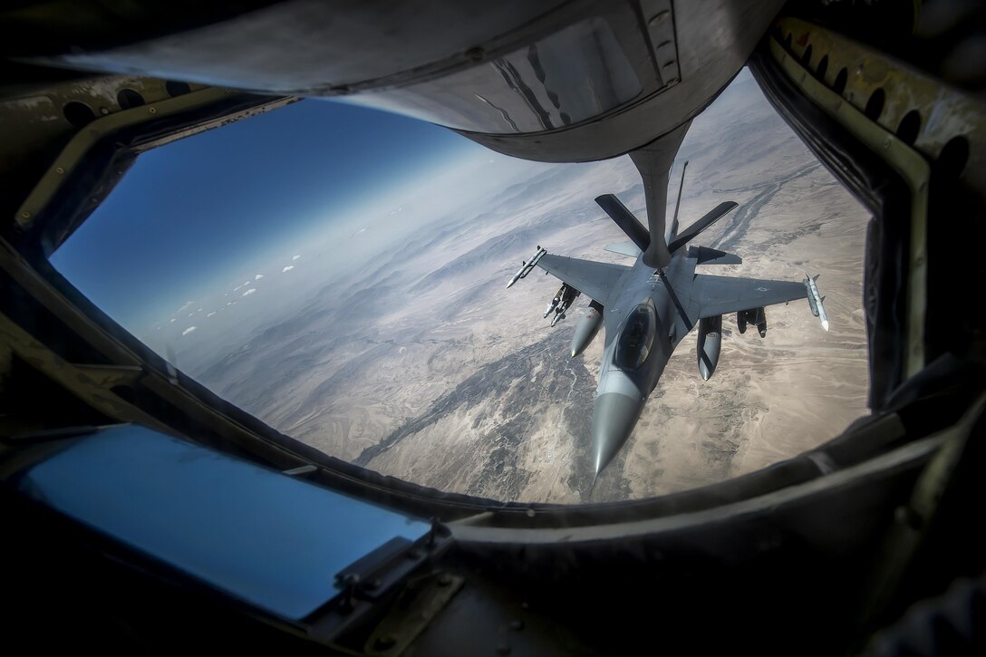 An Air Force F-16 Fighting Falcon receives fuel from a 340th Expeditionary Air Refueling Squadron KC-135 Stratotanker during a flight to support Operation Inherent Resolve over an undisclosed location, June 20, 2017. The unit delivers fuel to U.S. and coalition forces, enabling a 24/7 presence in the U.S. Central Command area of responsibility. Air Force photo by Staff Sgt. Trevor T. McBride