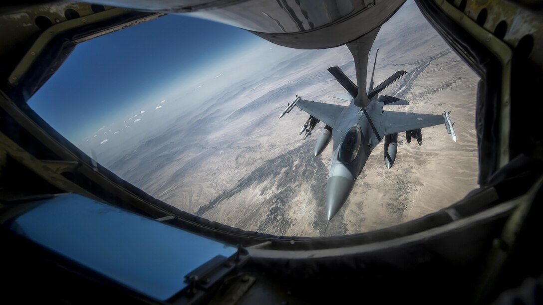 An Air Force F-16 Fighting Falcon receives fuel from a 340th Expeditionary Air Refueling Squadron KC-135 Stratotanker during a flight to support Operation Inherent Resolve over an undisclosed location, June 20, 2017. The unit delivers fuel to U.S. and coalition forces, enabling a 24/7 presence in the U.S. Central Command area of responsibility. Air Force photo by Staff Sgt. Trevor T. McBride