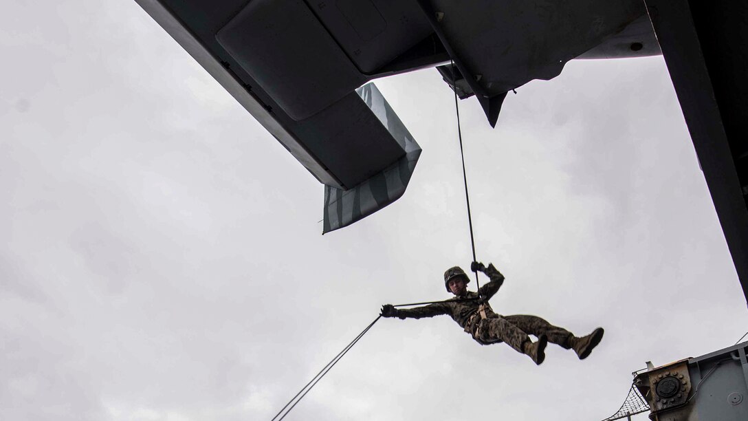 Marine Corps Lance Cpl. Will Bunch rappels from an MV-22B Osprey onto the port aircraft elevator of the amphibious assault ship USS Bonhomme Richard in the Coral Sea, June 26, 2017. The Richard is operating in the Indo-Asia-Pacific region to enhance partnerships and be a ready-response force for any type of contingency. Navy photo by Petty Officer 2nd Class Kyle Carlstrom