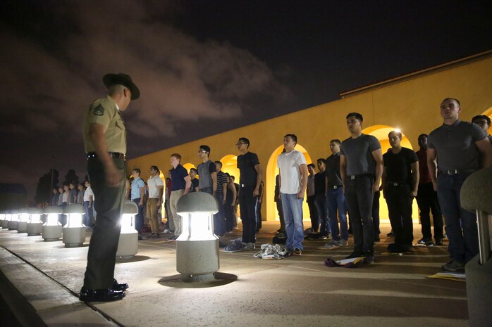 Recruits of Alpha Company, 1st Recruit Training Battalion, are welcomed to the depot as they stand on the yellow footprints during receiving at Marine Corps Recruit Depot San Diego, May 8. From this point on, recruits will eat, sleep and train as a team as they begin the transformation from civilian to Marine. Annually, more than 17,000 males recruited from the Western Recruiting Region are trained at MCRD San Diego. Alpha Company is scheduled to graduate Aug. 4.