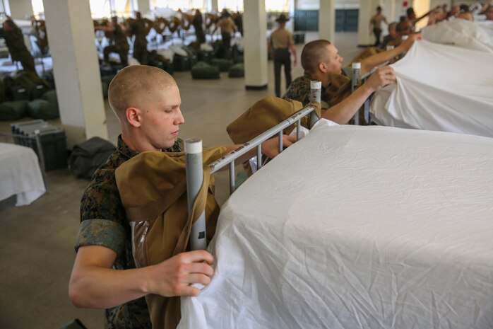 Recruits with Alpha Company, 1st Recruit Training Battalion, make their racks during pick up at Marine Corps Recruit Depot San Diego, May 12. From now on, recruits are held to a standard while making their racks and will be expected to do it quickly and proficiently every morning. Annually, more than 17,000 males recruited from the Western Recruiting Region are trained at MCRD San Diego. Alpha Company is scheduled to graduate Aug. 4.