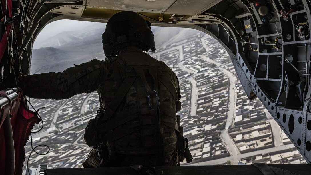An Army Reserve CH-47 Chinook helicopter pilot deployed with  scans below over Kandahar, Afghanistan, June 21, 2017. The soldier is assigned to the 7th Infantry Division's Task Force Warhawk, 16th Combat Aviation Brigade. The Warhawks provide aviation support to U.S. Forces Afghanistan as part of Operation Freedom's Sentinel. Army photo by Capt. Brian Harris