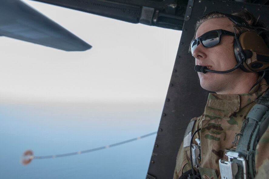 A U.S. Air Force MC-130H Combat Talon II loadmaster from the 353rd Special Operations Group observes a Japan Air Self-Defense Force UH-60J helicopter assigned to the Hamamatsu Air Rescue Squadron above the Pacific Ocean, June 15, 2017, during helicopter air-to-air refueling training. The 353rd SOG conducted a 10-day long joint combined exchange training exercise with JASDF rescue squadrons. (U.S. Air Force photo by Yasuo Osakabe)