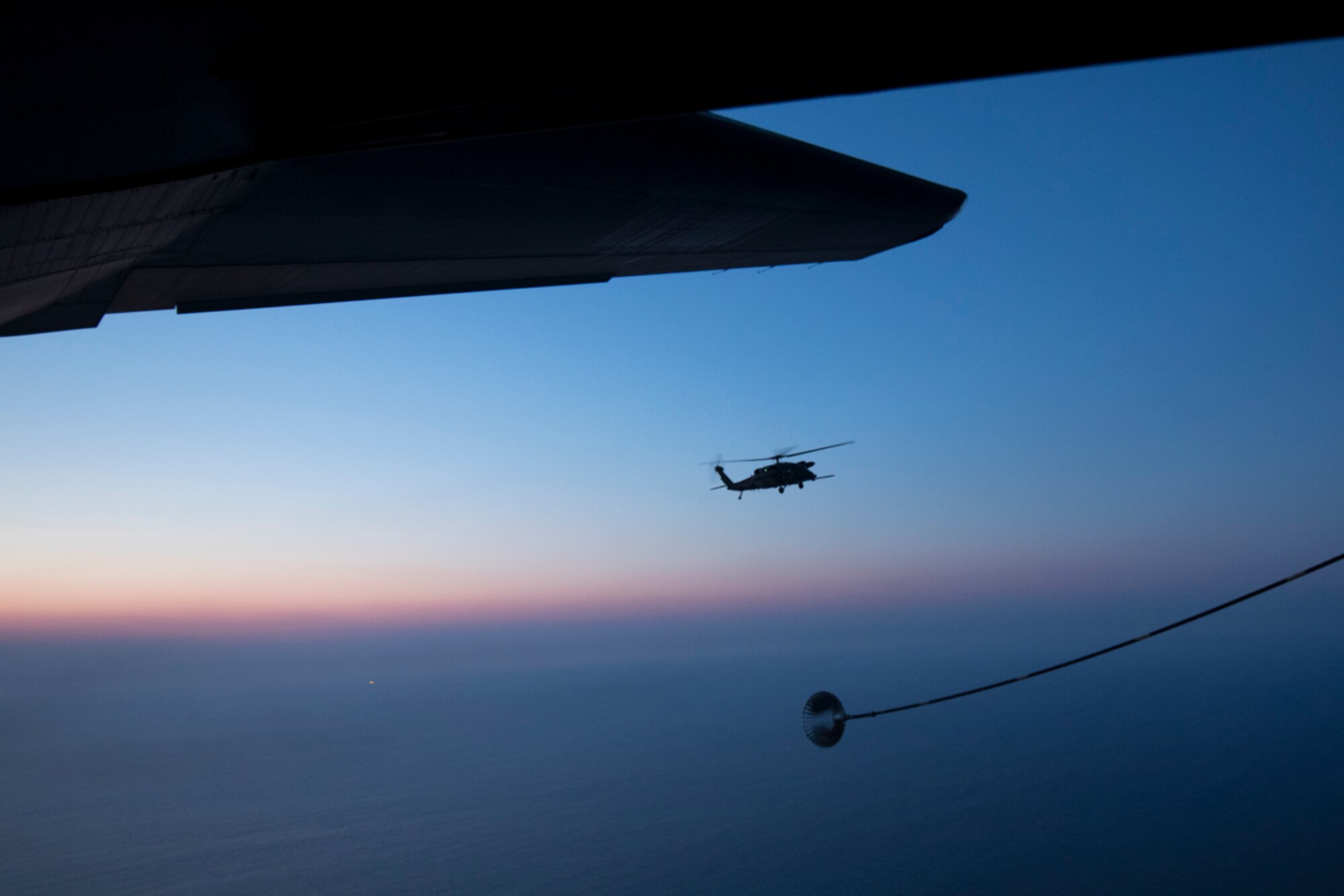 A Japan Air Self-Defense Force UH-60J Black Hawk helicopter assigned to the Hamamatsu Air Rescue Squadron approaches a U.S. Air Force MC-130H Combat Talon II assigned to the 353rd Special Operations Group during helicopter air-to-air refueling training over the Pacific Ocean, June 15, 2017. The 353rd SOG conducted a 10-day long joint combined exchange training exercise with JASDF rescue squadrons. (U.S. Air Force photo by Yasuo Osakabe)