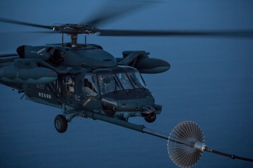 A Japan Air Self-Defense Force UH-60J Black Hawk assigned to the Hamamatsu Air Rescue Squadron executes a helicopter air-to-air refueling over the Pacific Ocean, June 15, 2017, during Exercise Teak Jet. This is the first time that members of the 353rd Special Operations Group held HAAR training at night with JASDF members in Honshu Island in Japan.  (U.S. Air Force photo by Yasuo Osakabe)