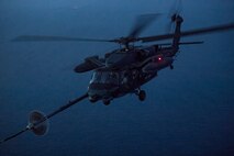 A Japan Air Self-Defense Force UH-60J Black Hawk assigned to the Hamamatsu Air Rescue Squadron executes helicopter air-to-air refueling over the Pacific Ocean, June 15, 2017, during Exercise Teak Jet. This is the first time that members of the 353rd Special Operations Group held HAAR training at night with JASDF members in Honshu Island in Japan. (U.S. Air Force photo by Yasuo Osakabe)