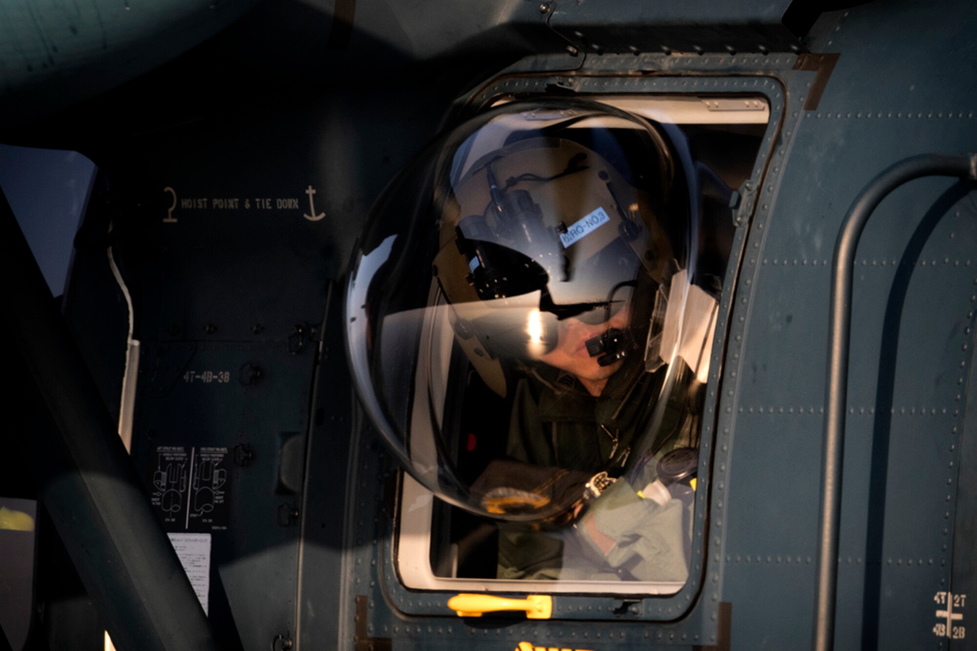 A Japan Air Self-Defense Force UH-60J Black Hawk flight engineer from the Komatsu Air Rescue Squadron performs a visual conformation during helicopter air-to-air refueling (HAAR) training over the Sea of Japan, June 19, 2017. This is the first time that members of the 353rd SOG held HAAR training at night with JASDF members in Honshu Island in Japan. Exercise Teak Jet is a joint combined exchange training (JCET) focused on improving interoperability between U.S. Air Force and Japan Air Self-Defense Force. (U.S. Air Force photo by Yasuo Osakabe)