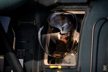 A Japan Air Self-Defense Force UH-60J Black Hawk flight engineer from the Komatsu Air Rescue Squadron performs a visual conformation during helicopter air-to-air refueling (HAAR) training over the Sea of Japan, June 19, 2017. This is the first time that members of the 353rd SOG held HAAR training at night with JASDF members in Honshu Island in Japan. Exercise Teak Jet is a joint combined exchange training (JCET) focused on improving interoperability between U.S. Air Force and Japan Air Self-Defense Force. (U.S. Air Force photo by Yasuo Osakabe)