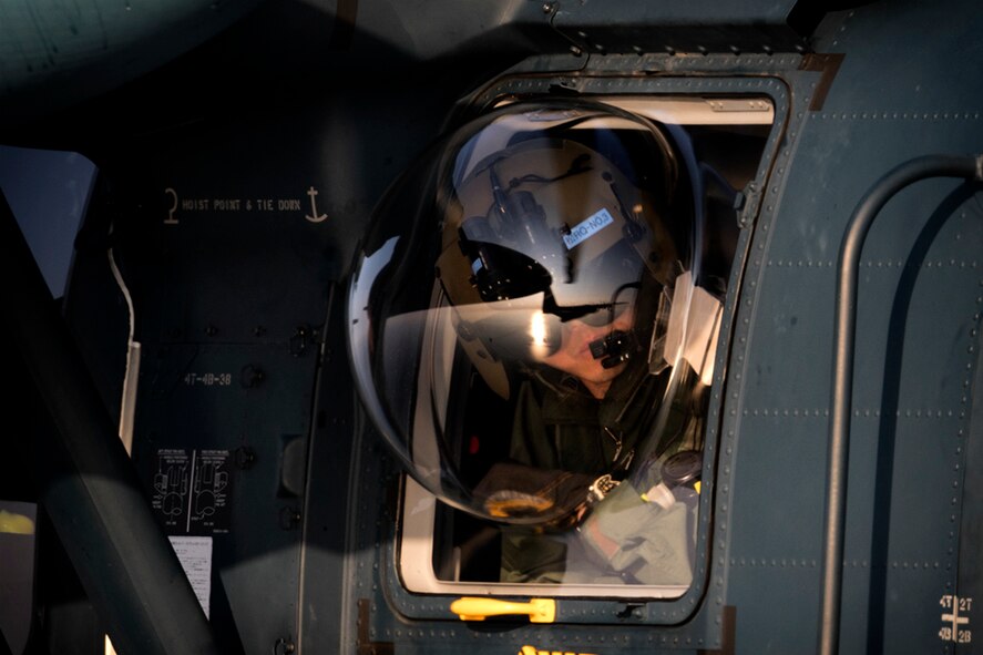 A Japan Air Self-Defense Force UH-60J Black Hawk flight engineer from the Komatsu Air Rescue Squadron performs a visual conformation during helicopter air-to-air refueling (HAAR) training over the Sea of Japan, June 19, 2017. This is the first time that members of the 353rd SOG held HAAR training at night with JASDF members in Honshu Island in Japan. Exercise Teak Jet is a joint combined exchange training (JCET) focused on improving interoperability between U.S. Air Force and Japan Air Self-Defense Force. (U.S. Air Force photo by Yasuo Osakabe)