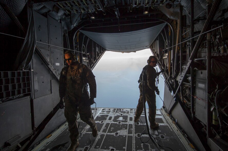 Loadmasters from the 353rd Special Operations Group secure the rear ramp of an MC-130H Combat Talon II over the Sea of Japan, June 19, 2017, during Exercise Teak Jet. The 353rd SOG members conducted helicopter air-to-air refueling training with Japan Air Self-Defense Force rescue squadron from the Komatsu Air Rescue Squadron This is the first time that members of the 353rd SOG held HAAR training at night with JASDF members in Honshu Island in Japan.  (U.S. Air Force photo by Yasuo Osakabe)