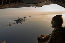 A U.S. Air Force loadmaster from the 353rd Special Operations Group observes a Japan Air Self-Defense Force UH-60J Black Hawk helicopter assigned to the Komatsu Air Rescue Squadron above the Sea of Japan, June 19, 2017, during Exercise Teak Jet. This is the first time that members of the 353rd SOG held HAAR training at night with JASDF members in Honshu Island in Japan. Exercise Teak Jet is a joint combined exchange training (JCET) focused on improving interoperability between U.S. Air Force and Japan Air Self-Defense Force. (U.S. Air Force photo by Yasuo Osakabe)