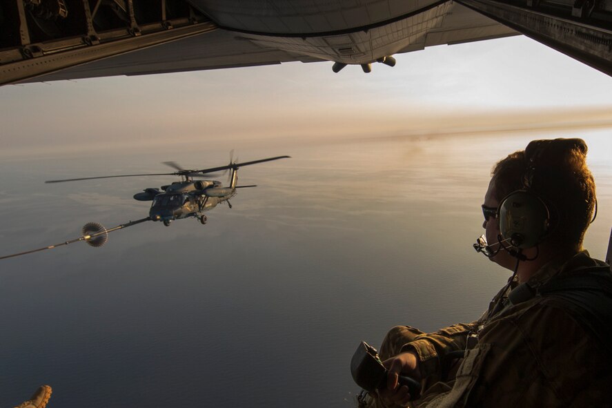 A U.S. Air Force loadmaster from the 353rd Special Operations Group observes a Japan Air Self-Defense Force UH-60J Black Hawk helicopter assigned to the Komatsu Air Rescue Squadron above the Sea of Japan, June 19, 2017, during Exercise Teak Jet. This is the first time that members of the 353rd SOG held HAAR training at night with JASDF members in Honshu Island in Japan. Exercise Teak Jet is a joint combined exchange training (JCET) focused on improving interoperability between U.S. Air Force and Japan Air Self-Defense Force. (U.S. Air Force photo by Yasuo Osakabe)