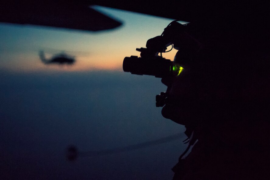 A U.S. Air Force loadmaster from the 353rd Special Operations Group performs visual conformation with a night vision goggle (NVG) during a helicopter air-to-air refueling (HAAR) training with the Japan Air Self Defense Force Komatsu Air Rescue Squadron above the Sea of Japan, June 19, 2017. This is the first time that members of the 353rd SOG held HAAR training at night with JASDF members in Honshu Island in Japan. Exercise Teak Jet is a joint combined exchange training (JCET) focused on improving interoperability between U.S. Air Force and Japan Air Self-Defense Force. (U.S. Air Force photo by Yasuo Osakabe)