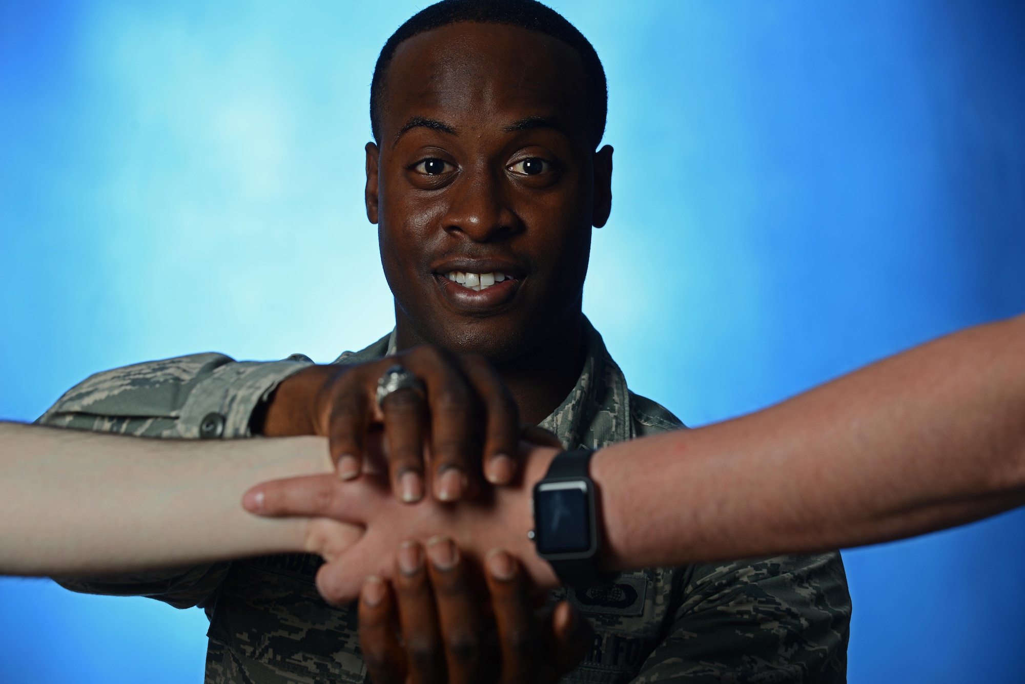 Air Force 1st Lt. Loyd Bradley, 673d Wing Staff Agency Finance Flight commander poses for a picture to show a platform he created with a local non-profit company that facilitates meetings between mentors and would-be mentees in the Anchorage area, June 20. The platform allows people to reach out to mentors and video chat with them for an hour to pick their brain before deciding whether to continue their professional relationship in the future. (U.S. Air Force photo by Senior Airman Kyle Johnson)